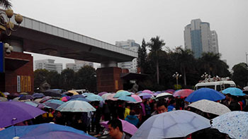 Even after it began raining, workers opened up their umbrellas and continued the protest